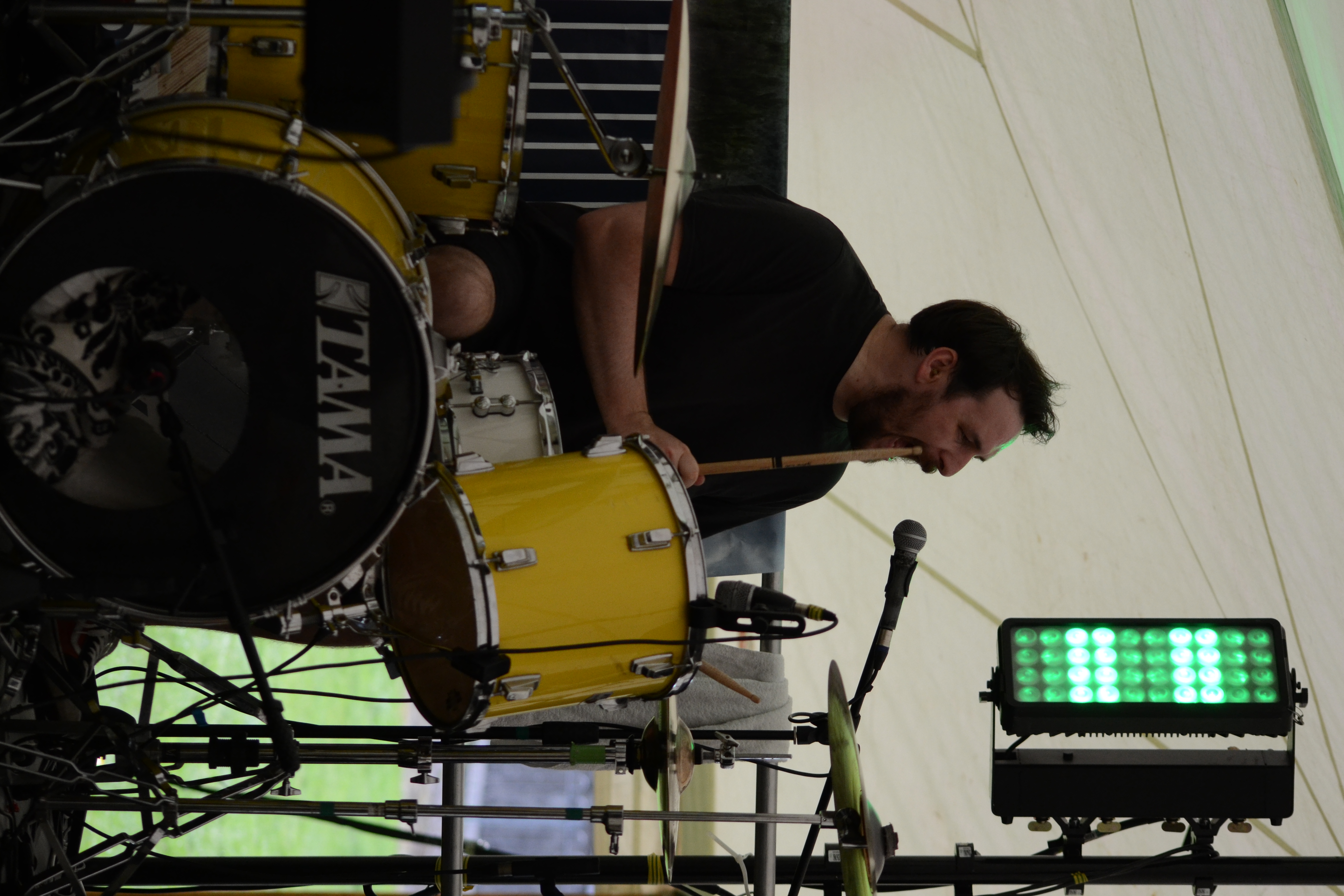 Bassist clapping overhead with bass strapped on during a performance break