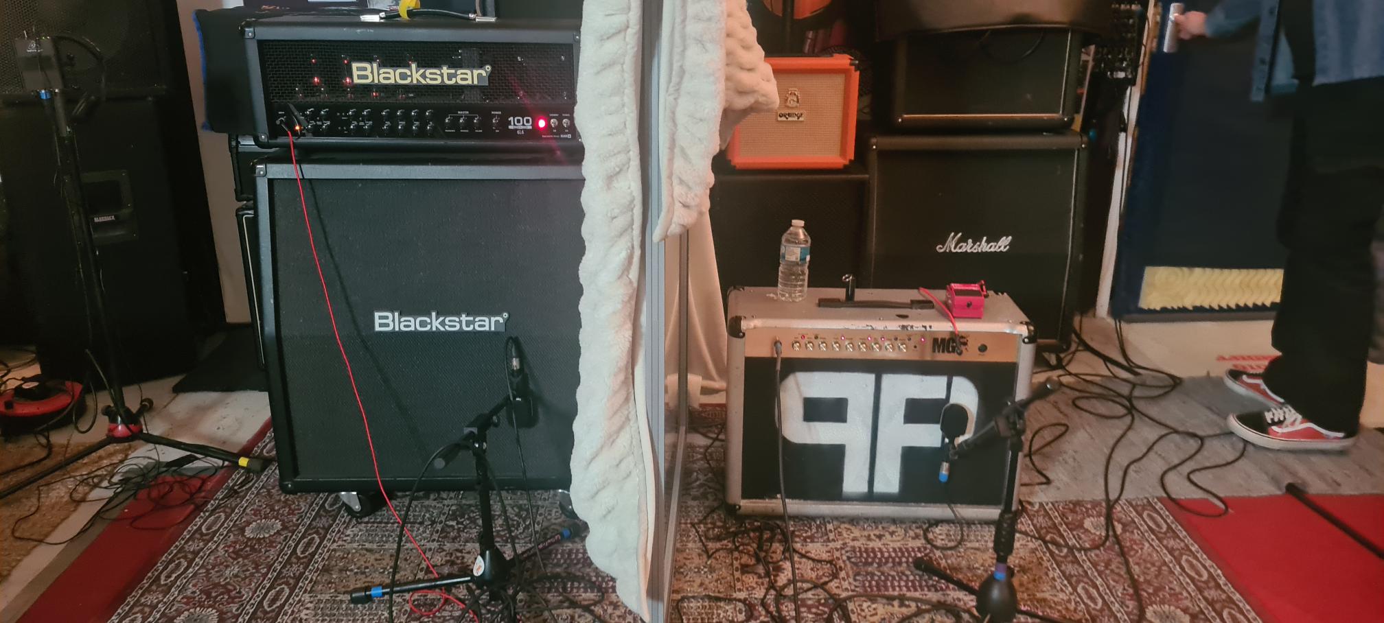 Mic'd guitar cabinets and amplifiers arranged in the live room