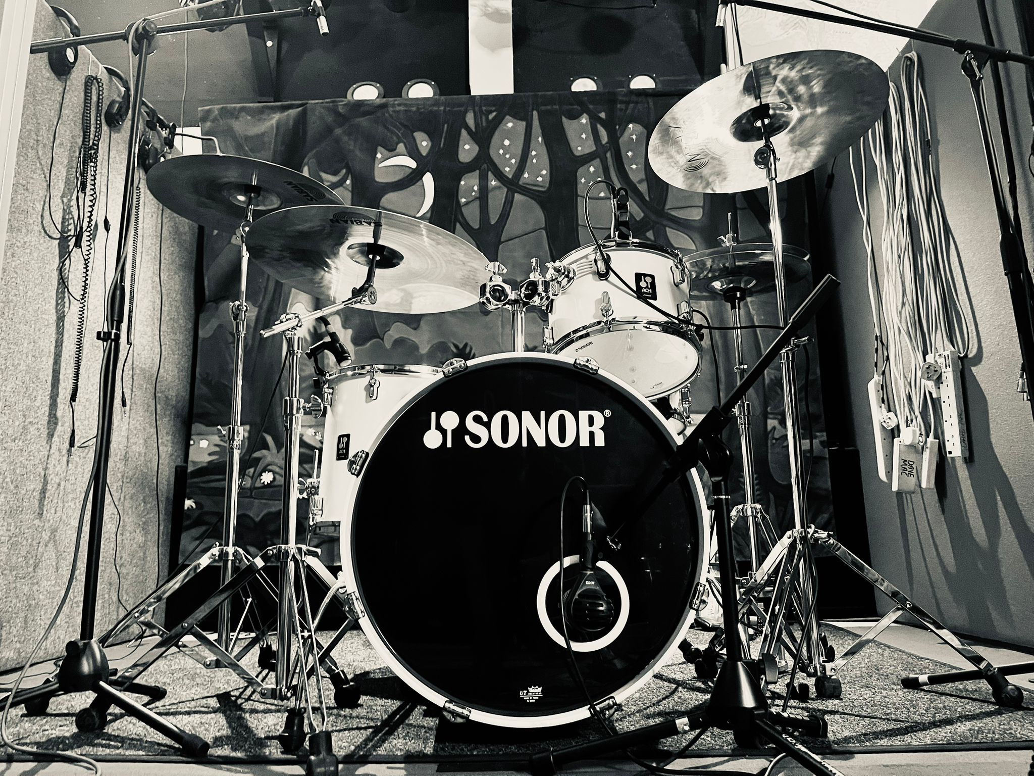 Black-and-white close-up of a mic'd Sonor drum kit in the live room